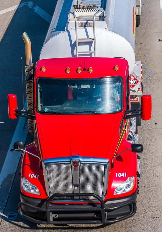 Red fuel tanker truck seen from above on a highway